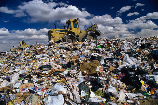 ca. 1991 --- Bulldozer on Trash Dump --- Image by © David Sailors/CORBIS
