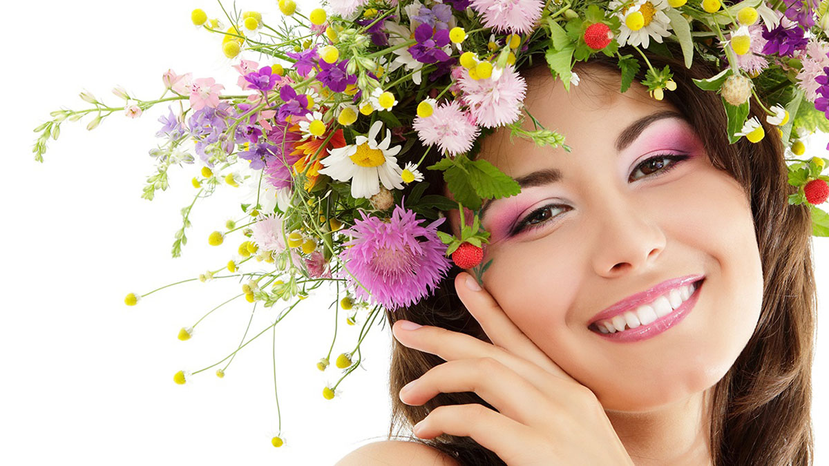 woman beauty face makeup with summer field wild flowers fresh na